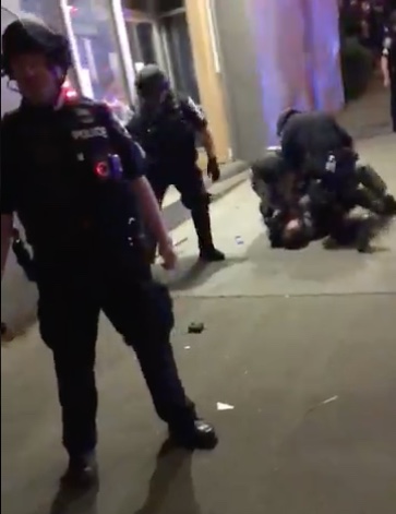 Photo of police officers in Austin using excessive force